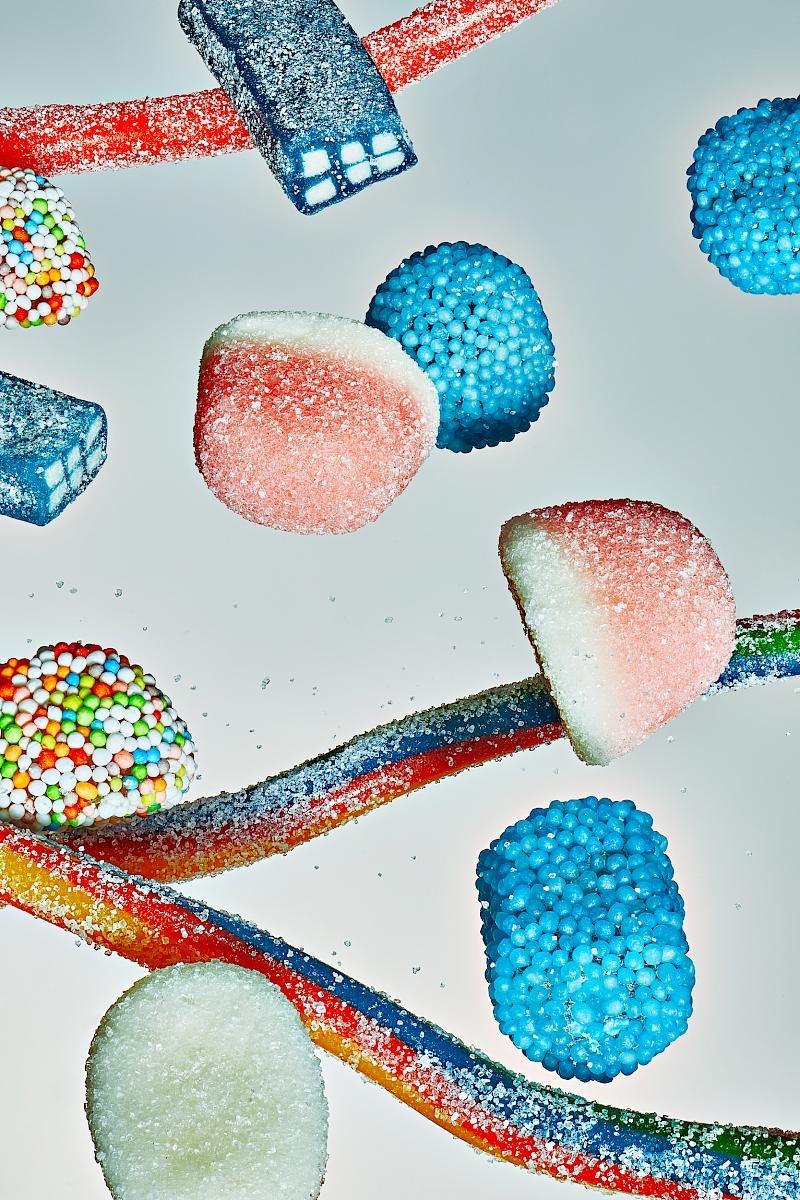 A Selection of Sour Sweets on a Gray Background